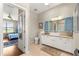 Well-lit bathroom with dual vanity, tile floor, and white cabinetry at 9628 Sw 90Th St, Ocala, FL 34481