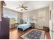 Cozy bedroom with hard floors, ceiling fan, and natural light from the windows at 9628 Sw 90Th St, Ocala, FL 34481