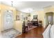 Dining room with hardwood floors, chandelier, and view of front door at 9628 Sw 90Th St, Ocala, FL 34481