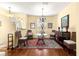 Bright dining room featuring a glass-top table, wicker chairs, and chandelier at 9628 Sw 90Th St, Ocala, FL 34481