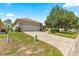 Well-maintained home with brick driveway, two-car garage, and verdant lawn, showcasing its curb appeal at 9628 Sw 90Th St, Ocala, FL 34481
