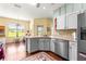 A bright kitchen featuring stainless appliances, white cabinets, granite countertops, and views at 9628 Sw 90Th St, Ocala, FL 34481
