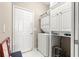 Functional laundry area featuring a stacked washer and dryer, ample cabinet space, and convenient storage solutions at 9628 Sw 90Th St, Ocala, FL 34481