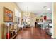 Open-concept living space with wood floors leading to the kitchen area at 9628 Sw 90Th St, Ocala, FL 34481