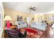 A spacious living room with hardwood floors, ceiling fan, and natural light at 9628 Sw 90Th St, Ocala, FL 34481
