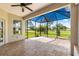Relaxing screened patio with pavers and ceiling fan offering outdoor living with serene golf course view at 9628 Sw 90Th St, Ocala, FL 34481