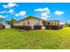 Exterior view of a charming home featuring a lush green backyard with well-manicured landscaping at 9642 Sw 95Th Loop, Ocala, FL 34481