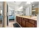 Elegant bathroom with double sinks, granite countertop, and walk-in shower with glass door at 9642 Sw 95Th Loop, Ocala, FL 34481