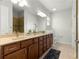 Bathroom with double sink vanity, granite countertop, and a large frameless glass shower at 9642 Sw 95Th Loop, Ocala, FL 34481