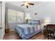 Comfortable bedroom with plenty of natural light and a ceiling fan at 9642 Sw 95Th Loop, Ocala, FL 34481