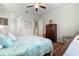 Inviting bedroom featuring hardwood floors, ceiling fan, and ample natural light at 9642 Sw 95Th Loop, Ocala, FL 34481