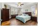 Bright bedroom with wood floors, ceiling fan, and generous natural light from two windows at 9642 Sw 95Th Loop, Ocala, FL 34481