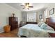 Comfortable bedroom featuring hardwood floors, large windows, and a modern ceiling fan at 9642 Sw 95Th Loop, Ocala, FL 34481