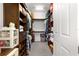 Spacious walk-in closet with custom shelving and ample storage space for organization at 9642 Sw 95Th Loop, Ocala, FL 34481