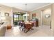 Dining room with wooden table and view of a screened-in porch through sliding glass doors at 9642 Sw 95Th Loop, Ocala, FL 34481