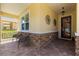 Inviting front porch featuring brick accents and comfortable seating at 9642 Sw 95Th Loop, Ocala, FL 34481