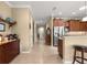Hallway leads to kitchen, showcasing access to pantry and lots of cabinet space at 9642 Sw 95Th Loop, Ocala, FL 34481