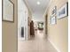Inviting hallway with tile flooring, decorative art, and a view into the dining area at 9642 Sw 95Th Loop, Ocala, FL 34481