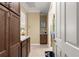 Hallway with tile floors, cabinets, and an open doorway into another room at 9642 Sw 95Th Loop, Ocala, FL 34481