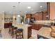 Stylish kitchen features granite countertops, stainless steel appliances, and breakfast bar seating at 9642 Sw 95Th Loop, Ocala, FL 34481
