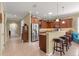 Well-lit kitchen with stainless steel refrigerator, breakfast bar, and granite countertops at 9642 Sw 95Th Loop, Ocala, FL 34481