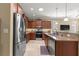 Modern kitchen with stainless steel refrigerator, granite countertops, and ample cabinet space at 9642 Sw 95Th Loop, Ocala, FL 34481