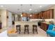 Spacious kitchen featuring modern appliances, granite countertops, and a breakfast bar with stools at 9642 Sw 95Th Loop, Ocala, FL 34481