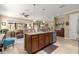 Open kitchen island boasts granite countertops, pendant lighting, and stainless steel appliances at 9642 Sw 95Th Loop, Ocala, FL 34481