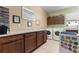 Functional laundry room with built-in cabinets, countertops, washer, and dryer at 9642 Sw 95Th Loop, Ocala, FL 34481