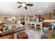 Inviting living room flows into kitchen, featuring a cozy sofa and modern ceiling fan at 9642 Sw 95Th Loop, Ocala, FL 34481