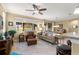 Inviting living room with a ceiling fan, comfortable seating, and large window with natural light at 9642 Sw 95Th Loop, Ocala, FL 34481