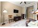 Comfortable office with a TV, book shelf, and a doorway leading to another room at 9642 Sw 95Th Loop, Ocala, FL 34481