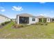 Well-maintained backyard featuring a screened-in lanai, lush lawn, and neatly landscaped garden beds at 10427 Sw 98Th Place Rd, Ocala, FL 34481