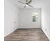 Bright, minimalist bedroom showcasing modern flooring, ample natural light, and a ceiling fan at 10427 Sw 98Th Place Rd, Ocala, FL 34481