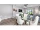 Dining area with glass table, white chairs, and view of the backyard at 10427 Sw 98Th Place Rd, Ocala, FL 34481