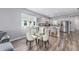 Dining room with modern white chairs and view to kitchen with stainless appliances at 10427 Sw 98Th Place Rd, Ocala, FL 34481