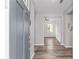 Inviting entryway featuring wood-look floors, neutral paint, and a view into the brightly lit living spaces at 10427 Sw 98Th Place Rd, Ocala, FL 34481