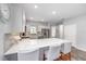 Contemporary kitchen featuring stainless appliances, quartz countertops and an island with seating at 10427 Sw 98Th Place Rd, Ocala, FL 34481