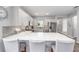 Well-lit kitchen features a large island with bar seating and stainless steel appliances at 10427 Sw 98Th Place Rd, Ocala, FL 34481