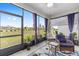 Relaxing lanai with comfortable seating, screened windows and views of the lush landscaping at 10427 Sw 98Th Place Rd, Ocala, FL 34481