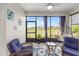 Relaxing lanai with comfortable seating, screened windows and views of the lush landscaping at 10427 Sw 98Th Place Rd, Ocala, FL 34481