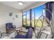 Relaxing lanai with comfortable seating, screened windows and views of the lush landscaping at 10427 Sw 98Th Place Rd, Ocala, FL 34481