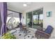 Relaxing lanai with comfortable seating, screened windows and views of the lush landscaping at 10427 Sw 98Th Place Rd, Ocala, FL 34481