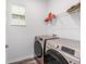 Efficient laundry room with modern washer and dryer, plus a convenient storage shelf above at 10427 Sw 98Th Place Rd, Ocala, FL 34481