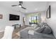Living area with grey sofa, glass table, and a sliding door with screened in patio at 10427 Sw 98Th Place Rd, Ocala, FL 34481