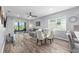 Bright living room features a ceiling fan, sliding glass door, and dining area at 10427 Sw 98Th Place Rd, Ocala, FL 34481