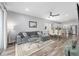 Open concept living space with stainless steel appliances and gray sofa and dining set at 10427 Sw 98Th Place Rd, Ocala, FL 34481