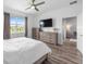 Bright main bedroom with ceiling fan, TV, and view of living space at 10427 Sw 98Th Place Rd, Ocala, FL 34481