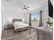 Light filled primary bedroom with ceiling fan and view to the outside at 10427 Sw 98Th Place Rd, Ocala, FL 34481