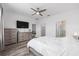 Primary bedroom has ceiling fan, dresser and ensuite bathroom with walk-in shower at 10427 Sw 98Th Place Rd, Ocala, FL 34481